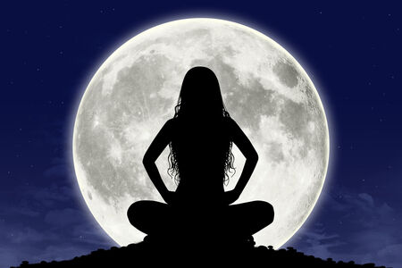 Woman silhouette in front of a full moon
