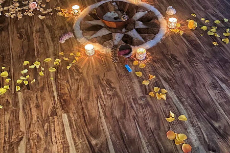 Flower Petal Centerpiece with a decoritve small rug and candles. 