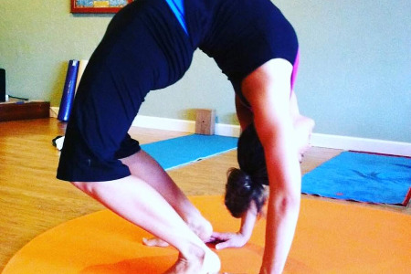 Jenna Lomazzo touching her heels in wheel pose 